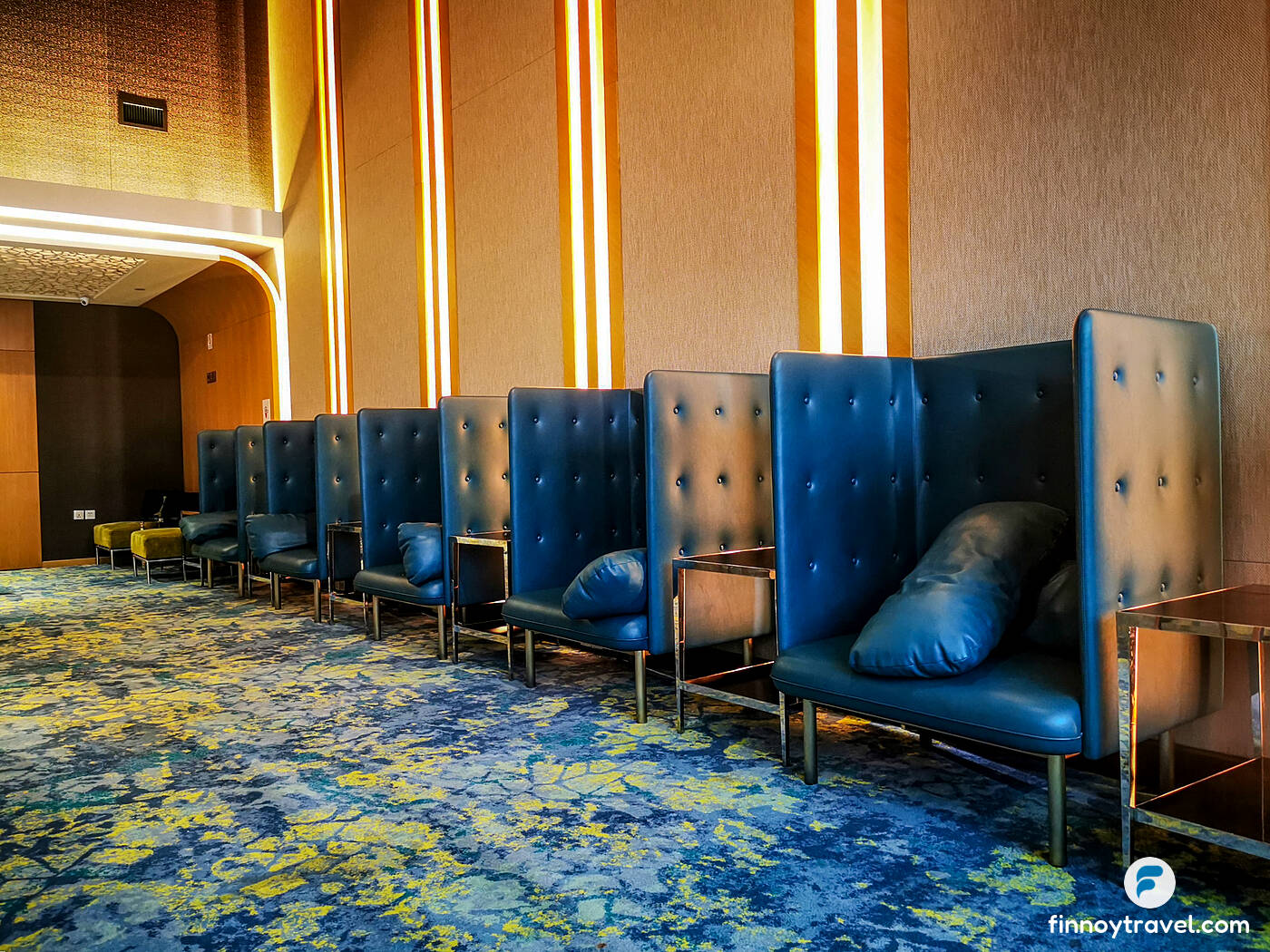 blue upholstered chairs of Ambassador Transit Lounge