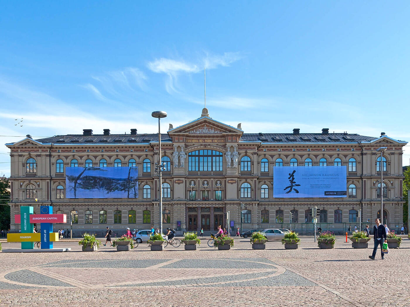 Museo de Arte Ateneum en Helsinki con una fachada hist&oacute;rica sim&eacute;trica, esculturas en el front&oacute;n y una gran plaza delante.