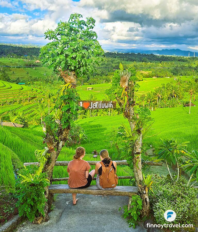 Tourists sitting on a bench at the Jatiluwih rice terraces