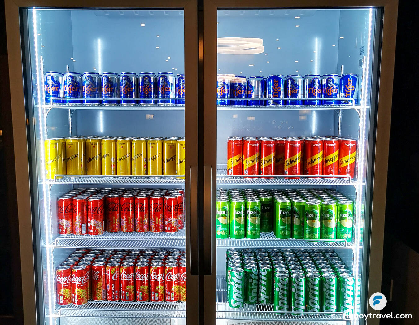 Canned soft drinks on the fridge of SATS Premier Lounge