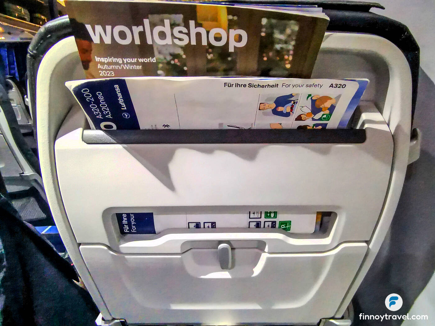 Instru&ccedil;&otilde;es de seguran&ccedil;a e menu da Lufthansa no bolso do encosto do assento